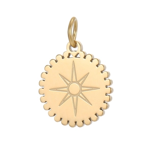 Detailed view of vintage gold round pendant with compass star and dotted edge