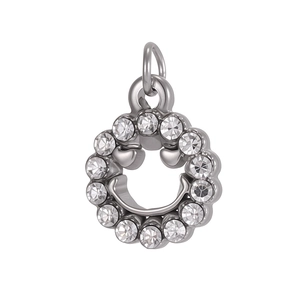 Macro detail of silver stainless steel pendant with heart-eye smiley face and crystal stones