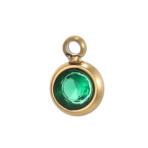 Detail of round gold pendant featuring a faceted emerald green zircon with a bail