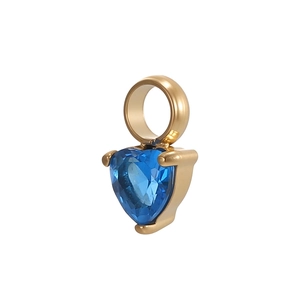 Macro shot of a heart-shaped blue zircon pendant with a polished gold plating finish