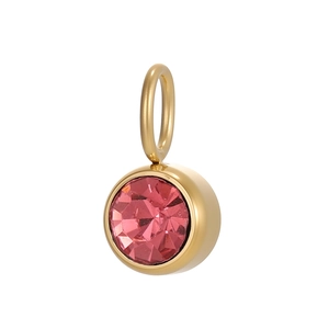 Macro shot of circular gold-plated pendant with faceted pink cubic zirconia stone inlay