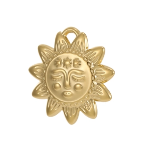 Macro detail of golden sun face pendant with textured rays for DIY jewelry making