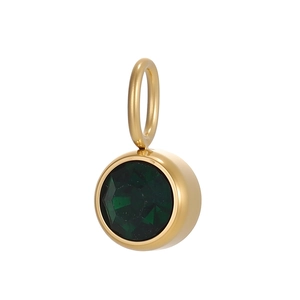 Detail of round gold pendant featuring a faceted green zircon inlay for DIY jewelry