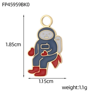 Detail view of cartoon astronaut pendant with navy enamel and red heart for DIY jewelry