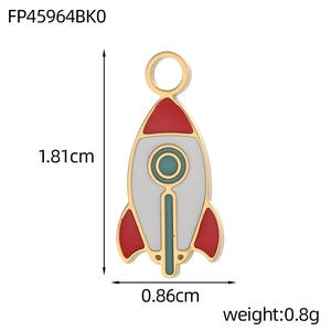 Detail view of colorful rocket enamel pendant with dimensions 1.81cm by 0.86cm