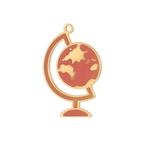 Macro detail of gold-plated globe charm with red enamel world map for DIY jewelry making