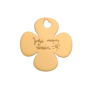 Detail of clover gold pendant with heart-shaped hole and engraved polish text art