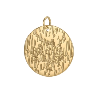 Detailed view of a round golden tree of life pendant with embossed metallic texture