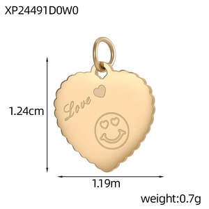 Detailed macro view of heart-shaped gold pendant with Love engraving and wavy edges