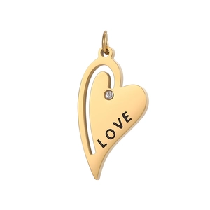 Detail of a golden heart pendant featuring a LOVE engraving and a small inlaid rhinestone