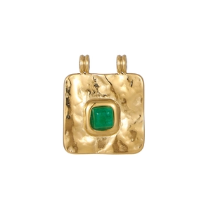 Detail of vintage square gold pendant featuring hammered metal texture and green stone