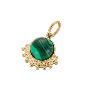 Macro shot of fan-shaped titanium steel pendant with malachite stone and bead border