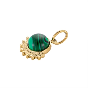 Macro shot of fan-shaped titanium steel pendant with green malachite stone and gold beads