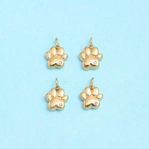 Detailed view of four golden stainless steel cat paw charms with sparkling zircon stone
