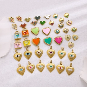 Collection of gold-plated stainless steel heart pendants with zircon and evil eye designs