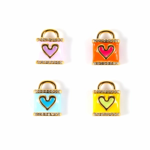 Macro shot of colorful heart handbag pendants with micro-inlaid crystals and gold plating