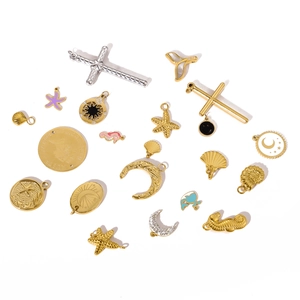 Detailed close-up of mixed celestial and marine charms with gold and silver metal finish