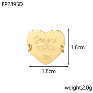 Detailed view of heart-shaped gold charm with Jedyna TAKA engraving for DIY jewelry