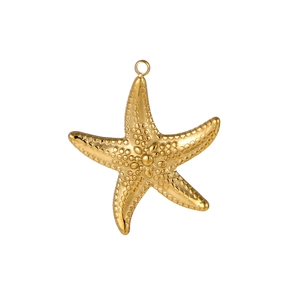 Macro shot of gold starfish jewelry pendant with textured relief for DIY necklaces