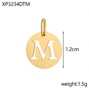Macro detail of a 1.2cm gold-plated stainless steel round pendant with letter M