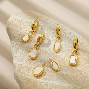 Golden oval shell charms with lobster clasps on stones, DIY jewelry accessories
