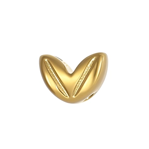 Detailed macro view of a polished golden heart charm bead for DIY jewelry making