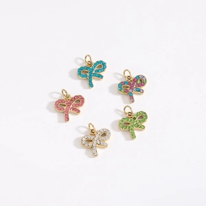 Macro shot of colorful crystal bow tie pendants with gold plating for jewelry DIY
