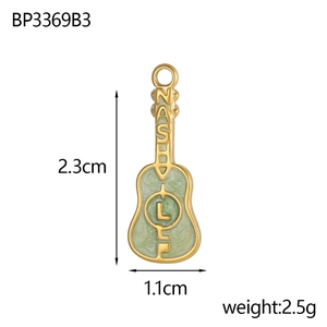 Macro detail of a 2.3cm green enamel guitar pendant with gold finish and NASTY lettering