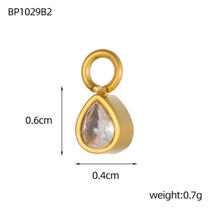 Detailed view of teardrop zircon pendant with 0.6cm height and 0.4cm width dimensions