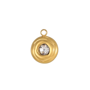 Detailed view of a gold-plated round pendant with lava texture and a clear faceted gemstone