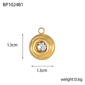 Detailed view of gold fan-shaped pendant with wavy texture and white zircon stone