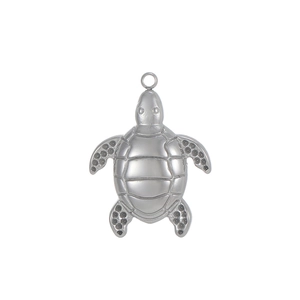 Macro detail of a silver sea turtle pendant with intricate shell engravings and metal loop