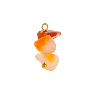 Detail of stacked colorful irregular raw stones with golden metal ring and bead accents