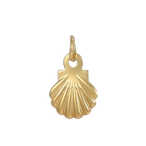 Macro shot of gold shell charm showing detailed ribbed texture and metallic luster
