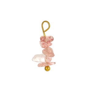 Close-up of pink crystal stone charms with golden metal beads for DIY jewelry making