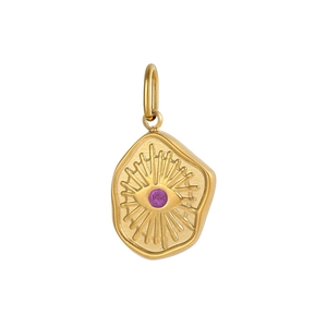 Macro view of a gold evil eye pendant with a purple gemstone and brushed metal texture