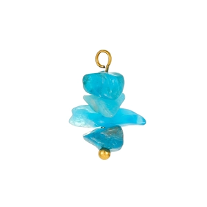 Detail of bohemian style stacked irregular blue natural stones with golden metal ring and beads