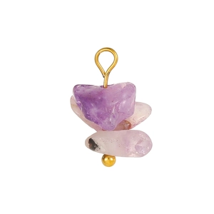 Close-up of handmade purple amethyst stone beads on a gold pin jewelry accessory