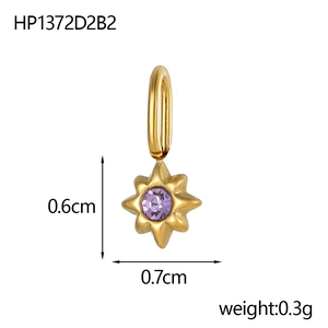 Macro shot of gold star pendant with purple gemstone and measurements 0.6cm by 0.7cm