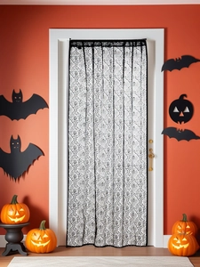 Close-up of Halloween door curtain with black handprints on white lace mesh fabric