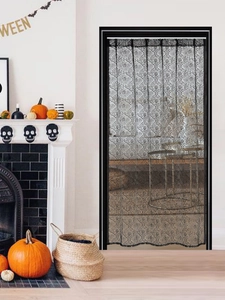 Detail of Halloween black lace curtain with spooky spider web and skull patterns