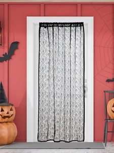 Close-up of black lace Halloween curtain featuring ghost hand pattern and mesh texture