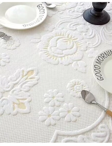 Detailed close-up of white embossed floral jacquard fabric with elegant rose patterns