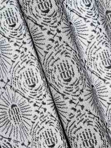 Close-up of black Hamsa hand print on white fabric for Halloween and bohemian curtains