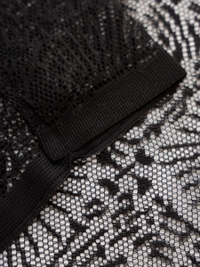 Close-up of black lace mesh fabric showing intricate hollow-out texture and fine craftsmanship