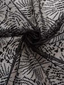 Close-up of black lace fabric with intricate floral patterns and hollow mesh structure
