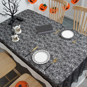 Black lace spider web tablecloth for Halloween party decor on a decorated table