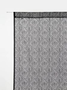 Close-up of Halloween ghost hand lace curtain with radial fan patterns and rod pocket