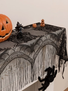 Detail of black lace fireplace scarf with bats, spider webs and decorative tassels