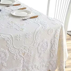 White embossed floral tablecloth with wavy edges and intricate jacquard textures